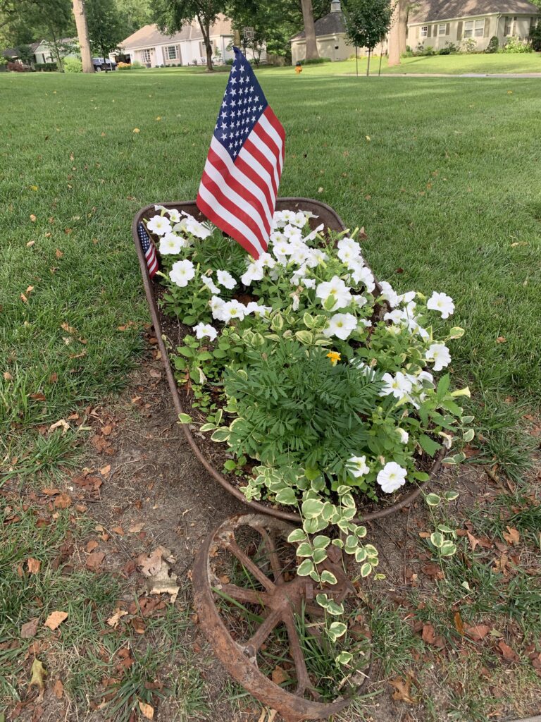 American flag in a rust wheelbarrow