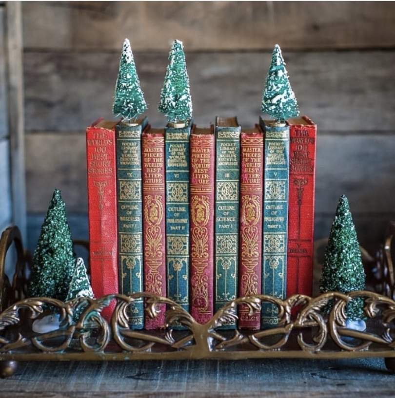 Stack of red and green books with Christmas trees