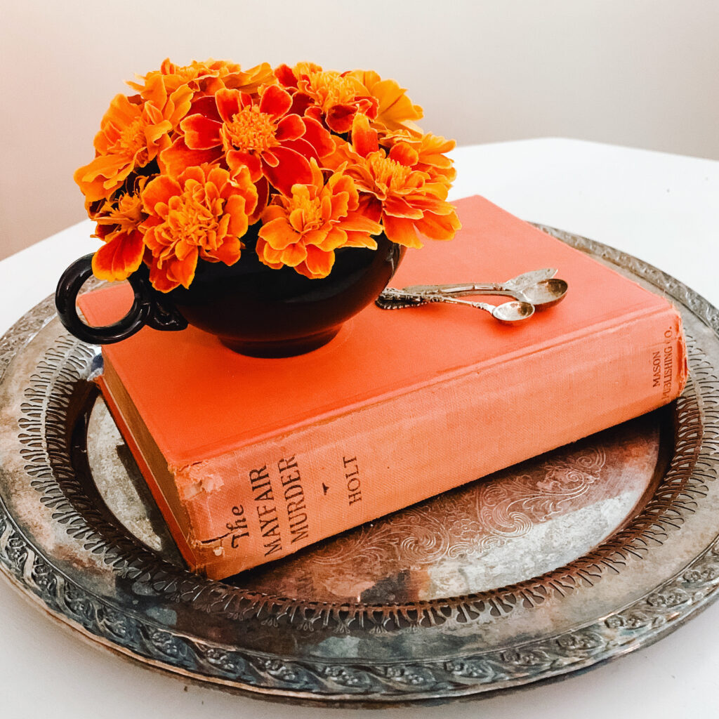 The Mayfair Murder vintage book with marigolds