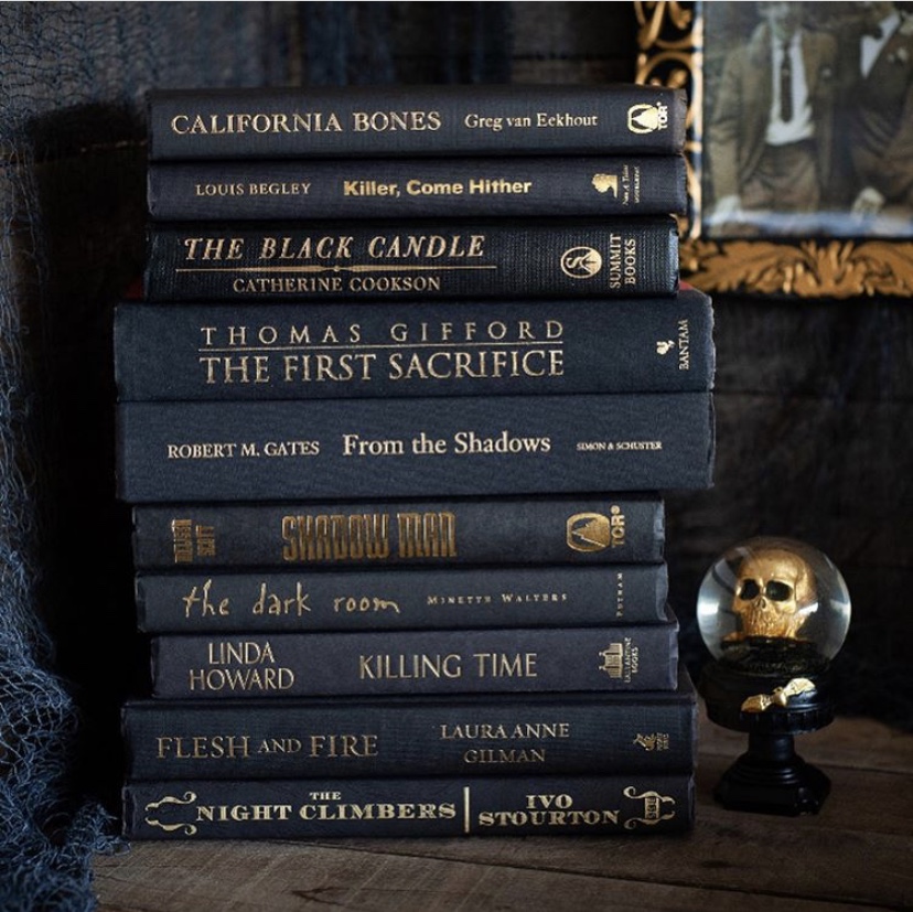 Stack of black Halloween inspired books