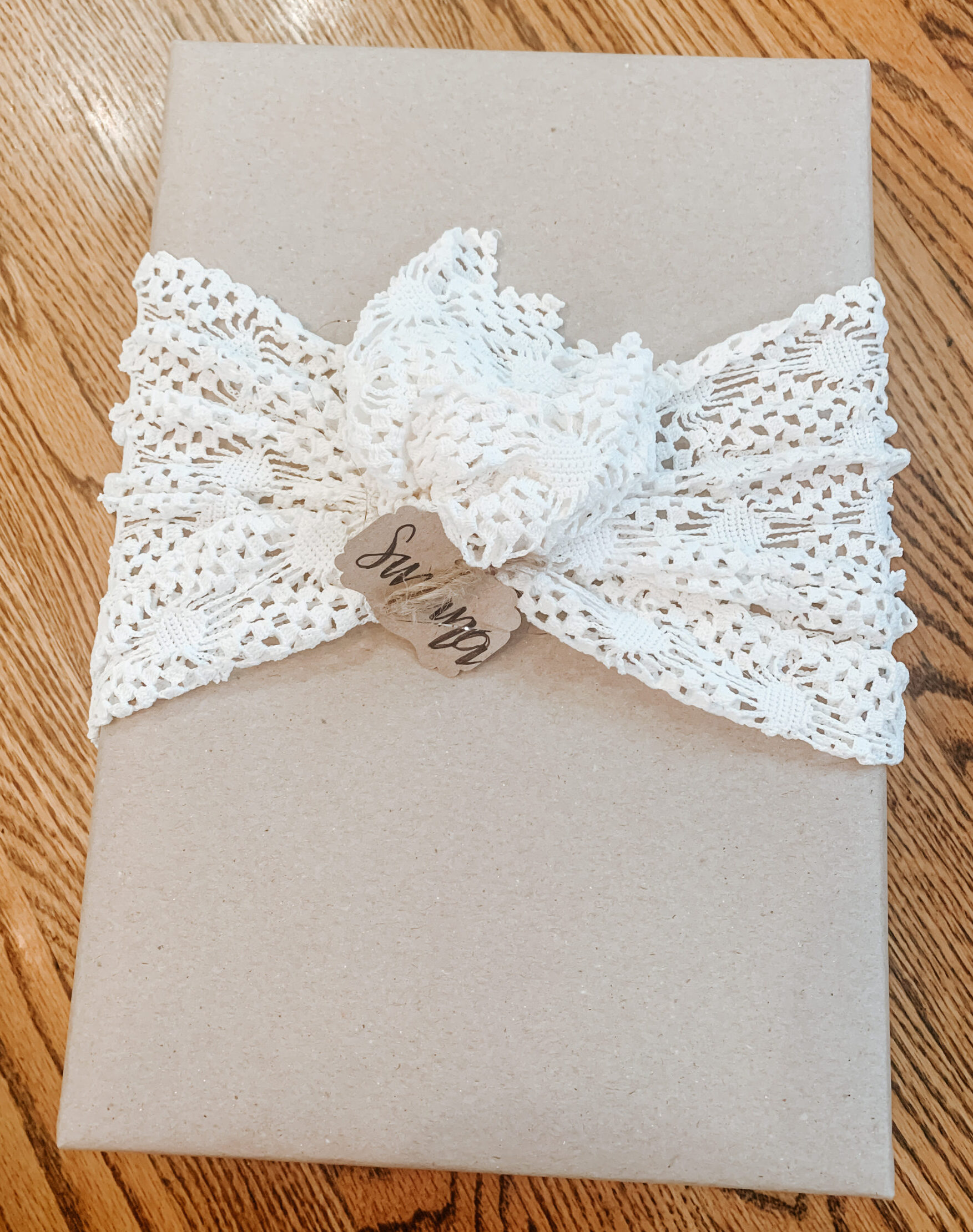 Doily wrapped around a brown paper package